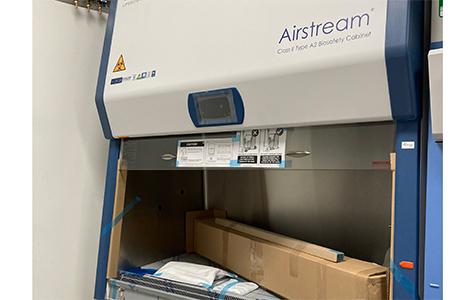 A new biosafety cabinet in the process of being unpackaged and set up for use.
