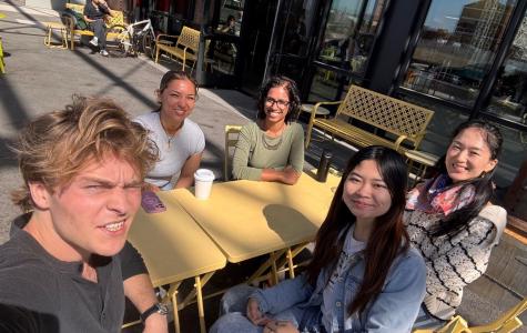 a group of people sitting around a yellow table